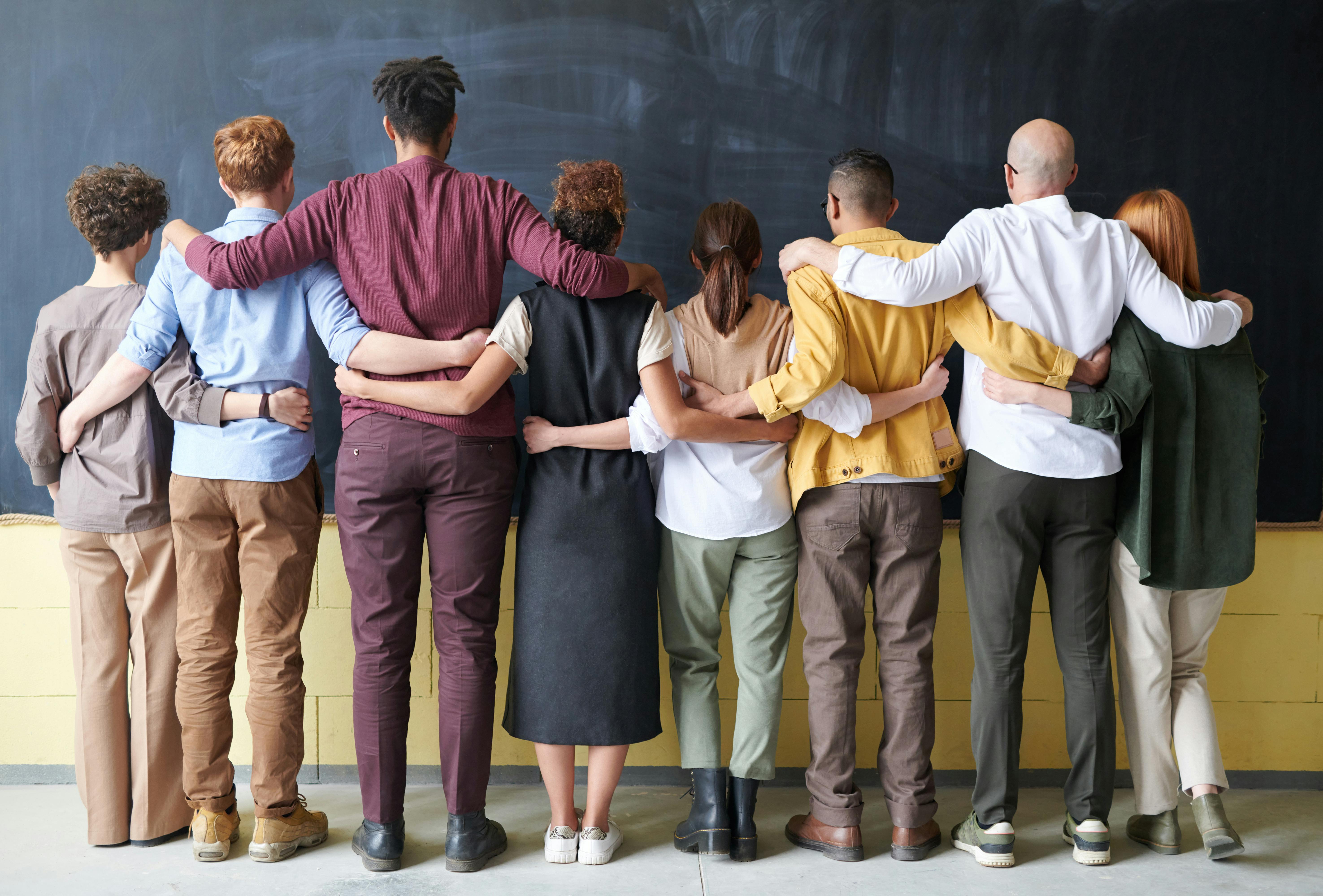 https://www.pexels.com/photo/group-of-people-standing-indoors-3184396/