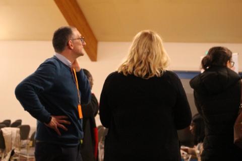 Three people standing among a crowd at OHM BP Cardio Health event in November 2023.