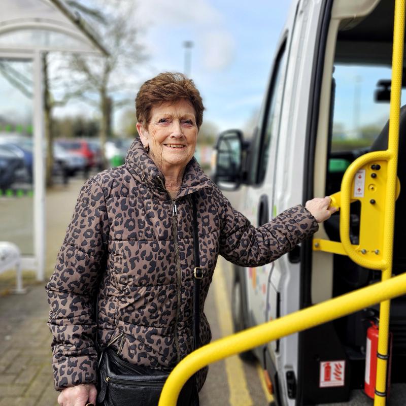 Smiling in front of the shopper bus