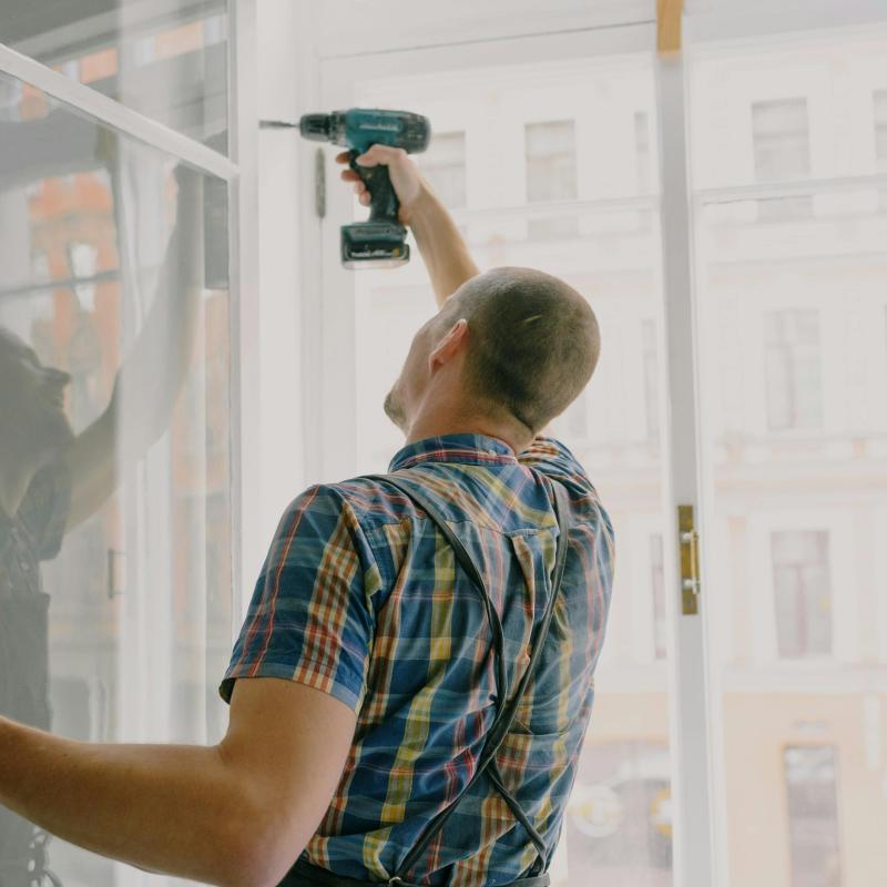 https://www.pexels.com/photo/handyman-installing-window-frame-with-drill-in-house-5691544/