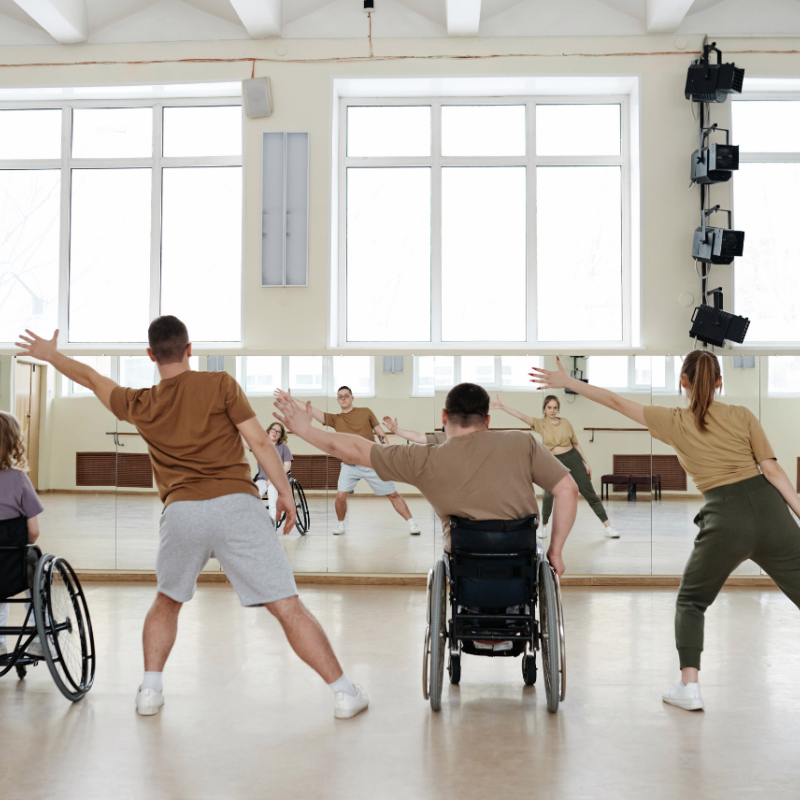 2 people in wheelchairs and 2 people not, all dancing.
