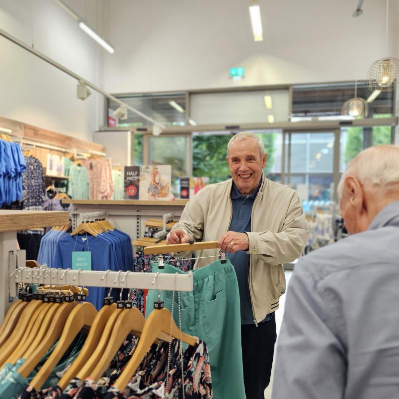 Two elderly men shopping in public.
