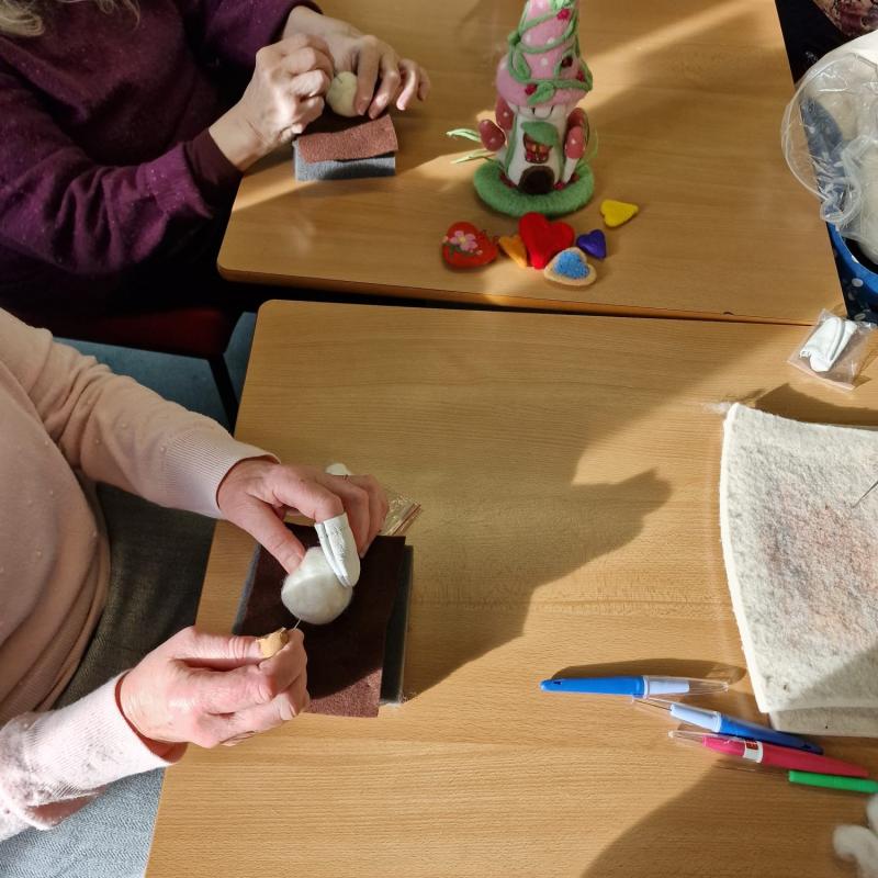 A photo of people participating with arts and crafts.