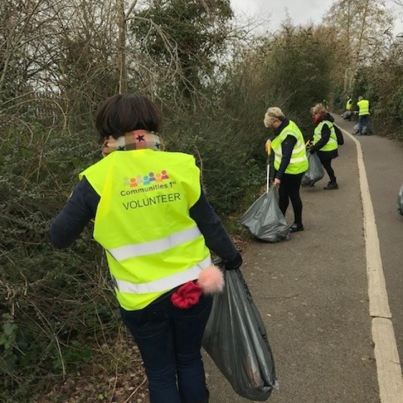 Volunteers litter picking on the side of a road