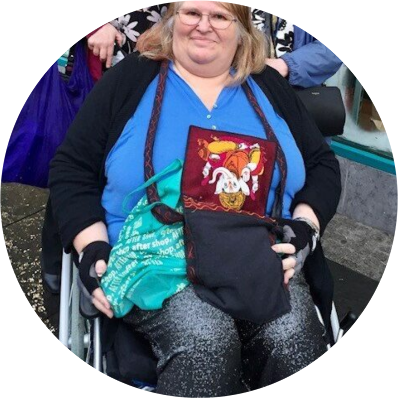 Jackie in her wheelchair, smiling