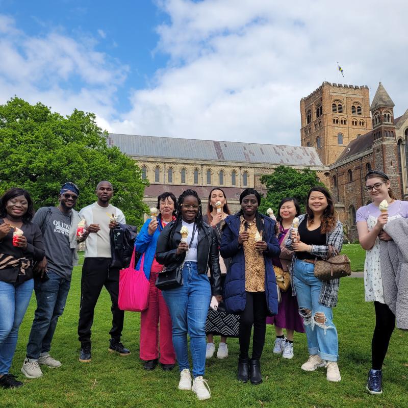International recruits and volunteers outside the St Albans Cathedral with ice creams