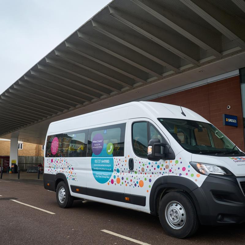 One of our Shopper Buses parked up outside a building.