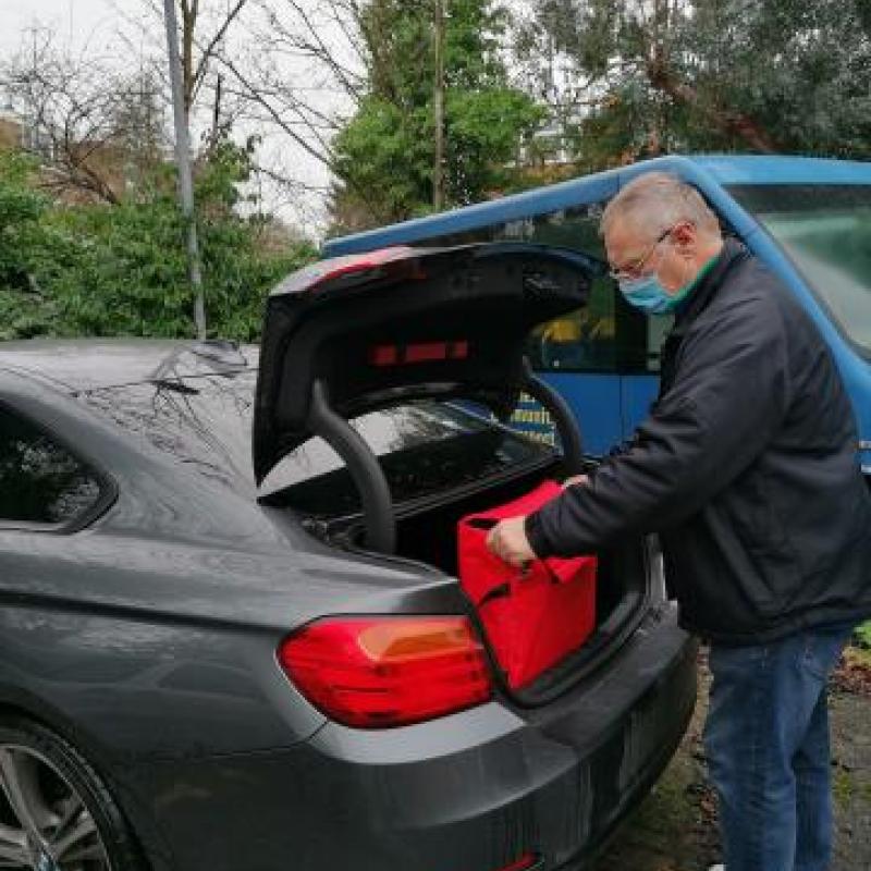 Somebody unloading a car.