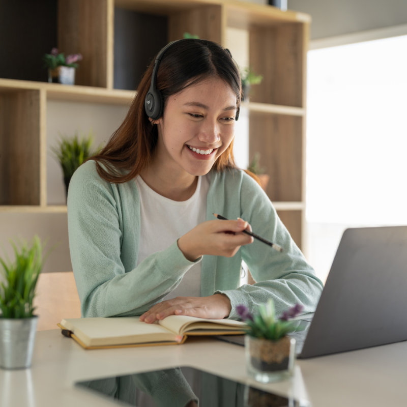 Woman smiling at her computer on a table