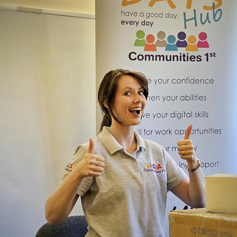 Health Volunteer Georgie giving the thumbs up while filming a vlog at C1st office