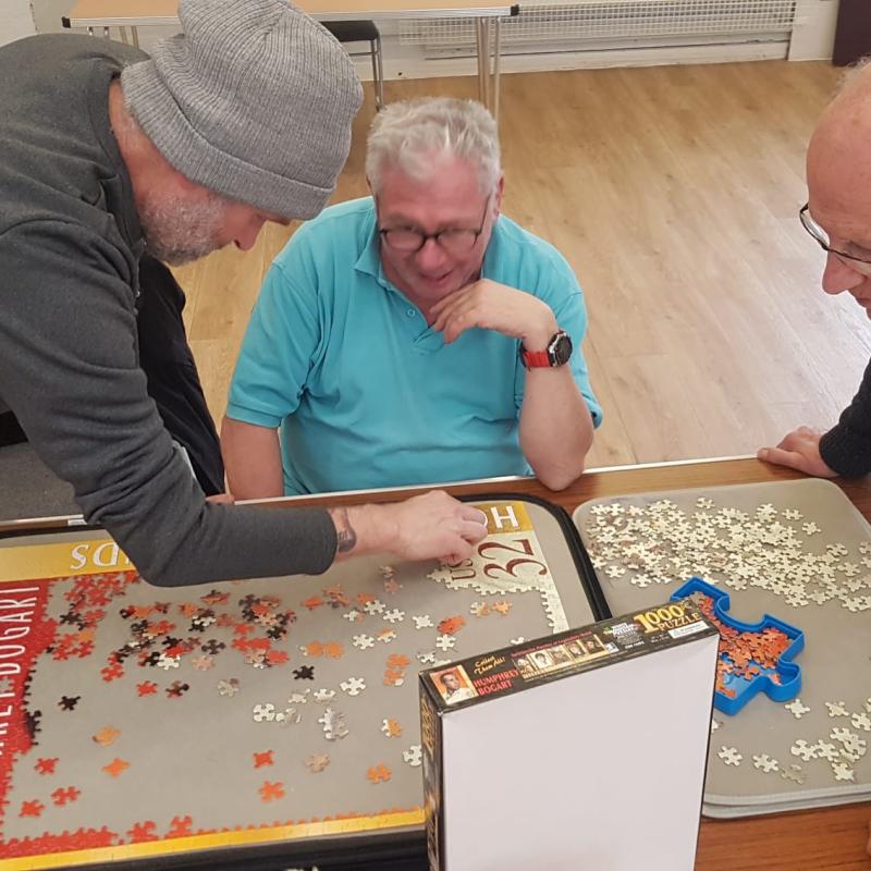 Men that Meet session - Friendly group doing a puzzle together